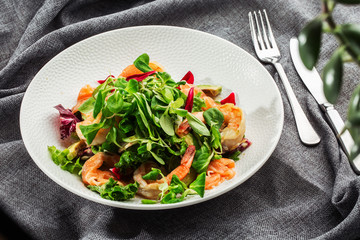 Healthy Salad. Recipe for fresh seafood. Grilled shrimps, prawns, fresh salad lettuce and avocado slices. Healthy Eating. White background. Horizontal photo.