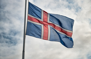 Waving flag of Iceland backlit at sunset
