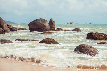 Fototapeta na wymiar Perfect beach and stones of the park Edge of Earth, Sanya, Chinese island of Hainan, vacation on the South China sea