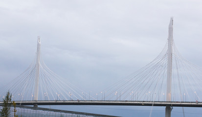 Fototapeta na wymiar Cable-stayed modern bridge on a background of cloudy sky in Saint-Petersburg, Russia.