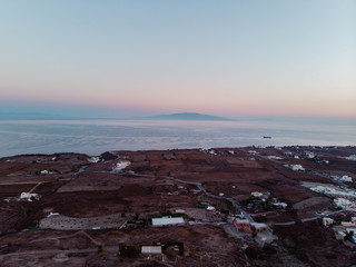 Aerial drone shot of a different side of Santorini. Arid and dry with an iconic church, this is the side tourists don't see. 