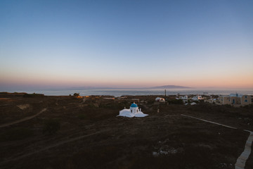 Aerial drone shot of a different side of Santorini. Arid and dry with an iconic church, this is the side tourists don't see. 