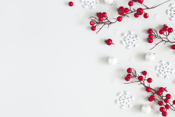 Christmas or winter composition. Snowflakes and red berries on gray background. Christmas, winter, new year concept. Flat lay, top view, copy space