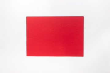 A red sheet of paper on a white background.