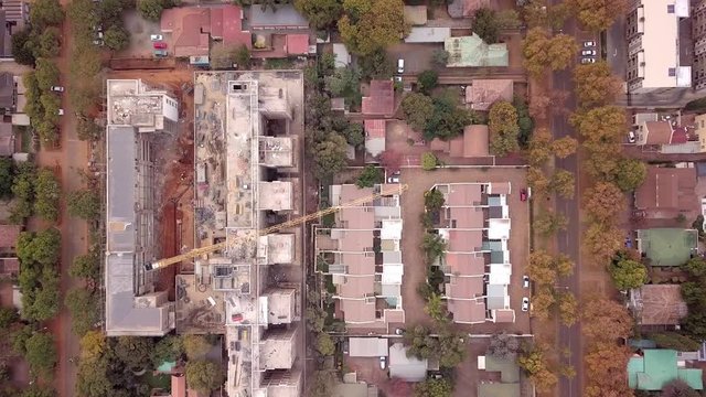 Close up of construction site of apartment building next to terraced houses, Pretoria, South Africa