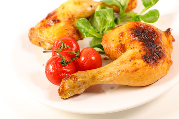grilled chicken leg and tomato isolated on white background