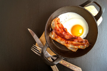 Sunny side up egg with fried bacon
