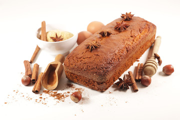 gingerbread cake with spices and ingredients on white background