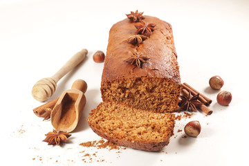 gingerbread cake with spices and ingredients on white background