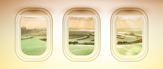 Airplane interior with window view of Dubai Pam Jumeirah Island, UAE. Concept of travel and air transportation