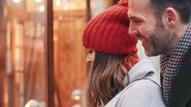 Mature couple looking at big shop display