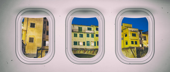 Airplane interior with window view of Florence Old Bridge, Italy. Concept of travel and air transportation
