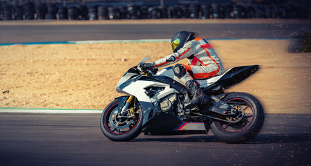 Obraz na płótnie Canvas motorcycle racer rides on a sports track
