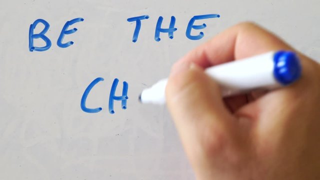 Be The Change Solgan On Whiteboard