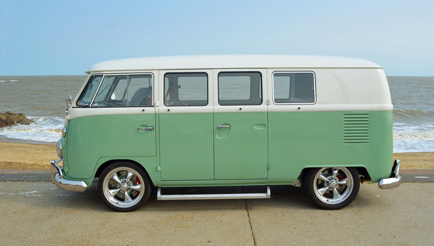 Classic Green and white Camper Van parked on Seafront Promenade.
