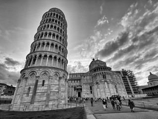 PISA, ITALY - SEPTEMBER 27, 2019: Field of Miracles at sunsetwith tourists