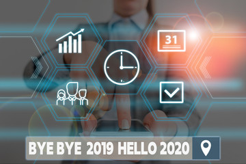 Conceptual hand writing showing Bye Bye 2019 Hello 2020. Concept meaning Starting new year Motivational message 2019 is over Woman wear work suit presenting presentation smart device © A