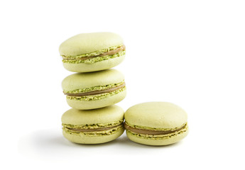 Green macarons or macaroons cakes isolated on white background,  side view.
