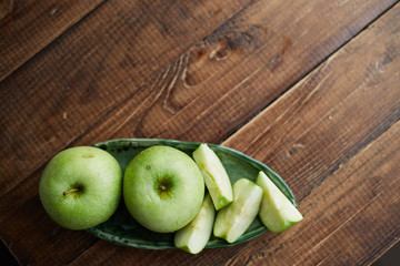 green apples on wooden background