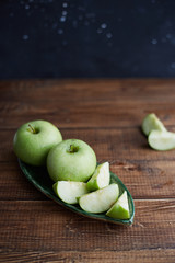 green apples on wooden background