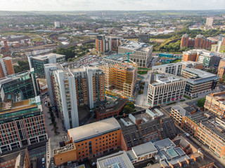 Fototapeta na wymiar Aerial photo taken on the centre of Leeds in the UK, showing the typical British town centre along with hotels, businesses and shopping centres, taken on a bright sunny part cloudy day