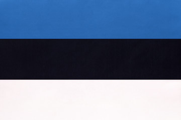 Estonia national fabric flag, textile background. Symbol of international world european country.