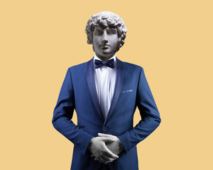 Modern art collage. Concept portrait of handsome stylish man in elegant blue suit .Gypsum head of...