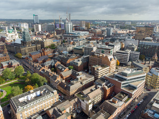 Obraz premium Aerial photo taken on the centre of Leeds in the UK, showing the typical British town centre along with hotels, businesses and shopping centres, taken on a bright sunny part cloudy day