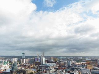 Naklejka premium Aerial photo taken on the centre of Leeds in the UK, showing the typical British town centre along with hotels, businesses and shopping centres, taken on a bright sunny part cloudy day