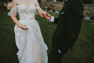 bride and groom holding their hands