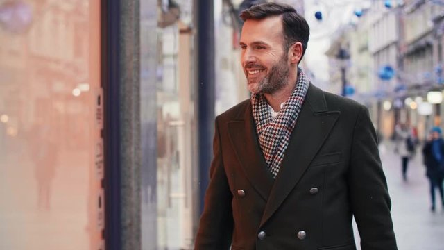 Mature man looking at window display