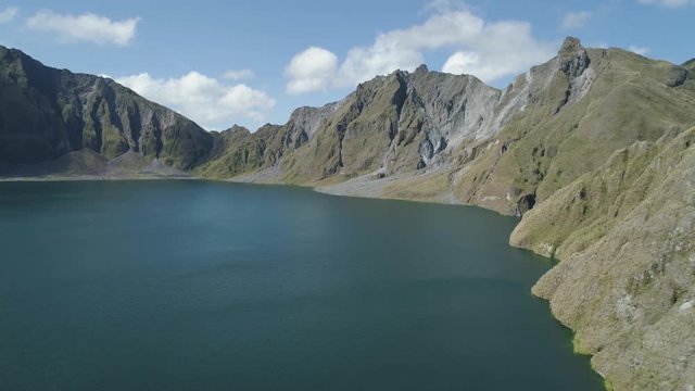 Crater Lake Pinatubo, Philippines, Luzon. Lake high in the mountains, aerial view. Beautiful mountain landscape with peaks of mountains and volcanoes. Mountain Lake.