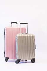 Pink and gray luggage trolley bag side isolated on white background, Compact plastic travel bag. Travel plan, trip vacation, tourism.