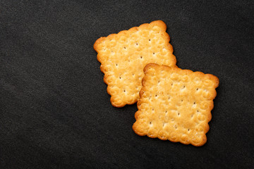 Cracker with sesame on black background.