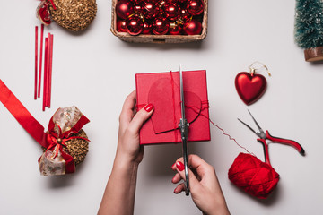 Christmas Background with women's hand wrapping Christmas Gift