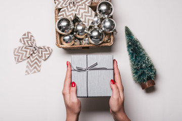 Christmas Background with women's hand wrapping Christmas Gift