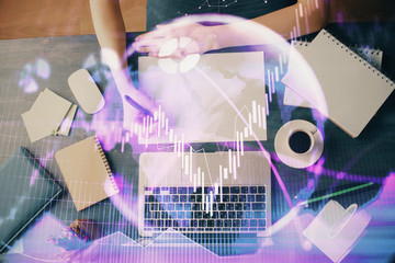 Financial graph displayed on woman's hand taking notes background. Concept of research. Multi exposure