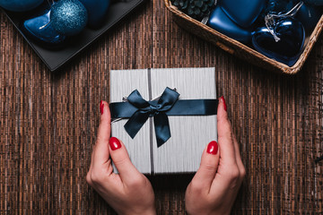 Christmas Background with women's hand wrapping Christmas Gift