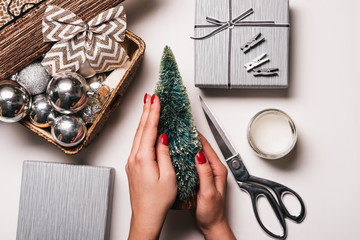 Christmas Background with women's hand wrapping Christmas Gift