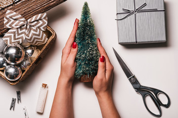 Christmas Background with women's hand wrapping Christmas Gift