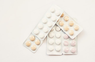 antibiotic pills and vitamins on a white background