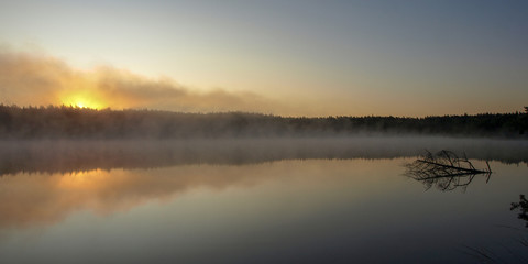Fototapeta na wymiar beautiful mist on the lake, outline, sunrise, autumn morning
