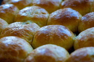 Baked hot buns. Sweet buns on a baking sheet.