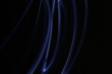 Abstract colorful irregular lines on black / green background photo with long exposure . Light painting photography. Lights with irregular patterns for overlay