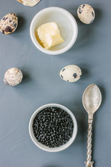 Top view of black caviar in white ceramic bowl.