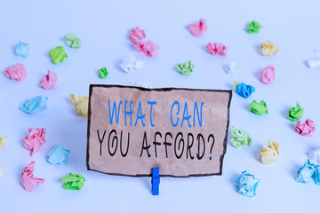 Text sign showing What Can You Afford Question. Business photo text Give us your budget availability of money Colored crumpled papers empty reminder white floor background clothespin