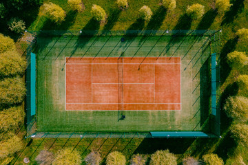 tennis field in the forest at sunset