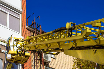 workers working with a car hydraulic lift, when working at high risk at altitude without an insurance rope, the front and rear background is blurred with a bokeh effect