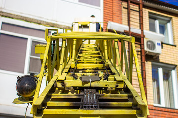 workers working with a car hydraulic lift, when working at high risk at altitude without an insurance rope, the front and rear background is blurred with a bokeh effect