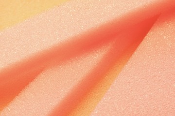 White and Pink artificial foam, foam texture on a light background.